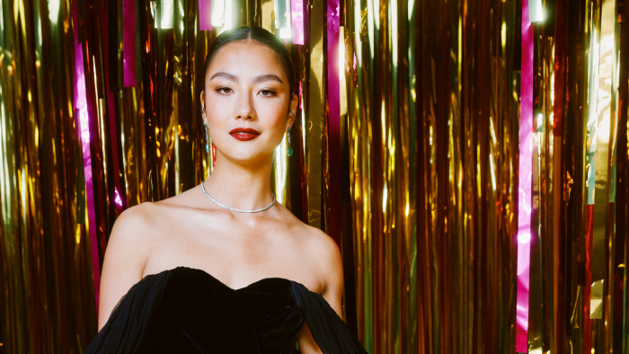 Adeline Rudolph poses in front of a sparkling background at the Unforgettable Gala 2021.