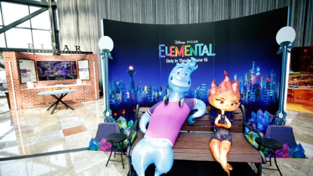 A image of Elemental characters Wade and Ember on a bench for fans to take photos with.