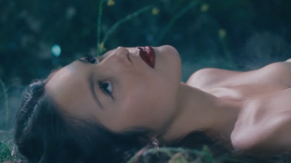 Olivia Rodrigo laying down in the music video of her new song 