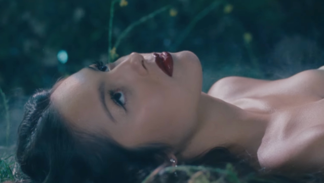 Olivia Rodrigo laying down in the music video of her new song 