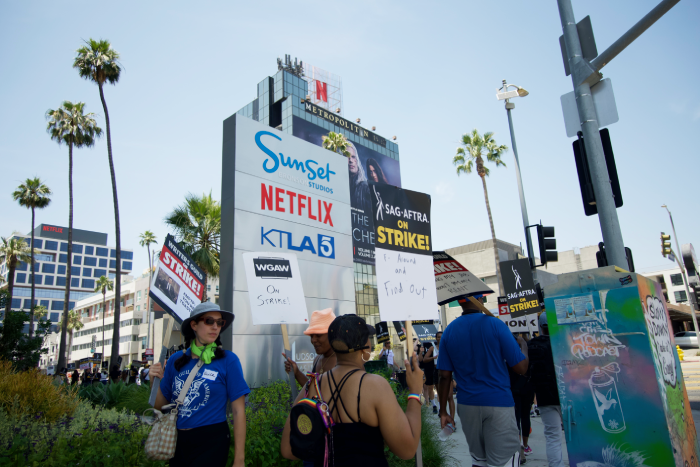 Actors and writes on strike in front of Netflix Studios in Los Angeles