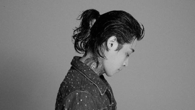 Bryan Chase poses in profile in a black-and-white photo.