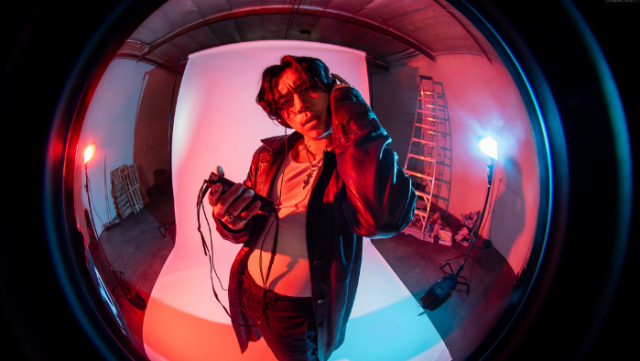 Tiktoker Michael Le posing in front of a blank canvas