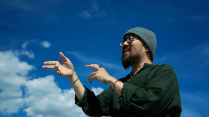 rapper jason chu posing with the sky in the background