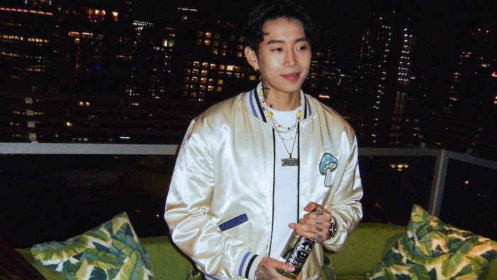 Jay Park holds a bottle of WON SOJU on a New York City rooftop.